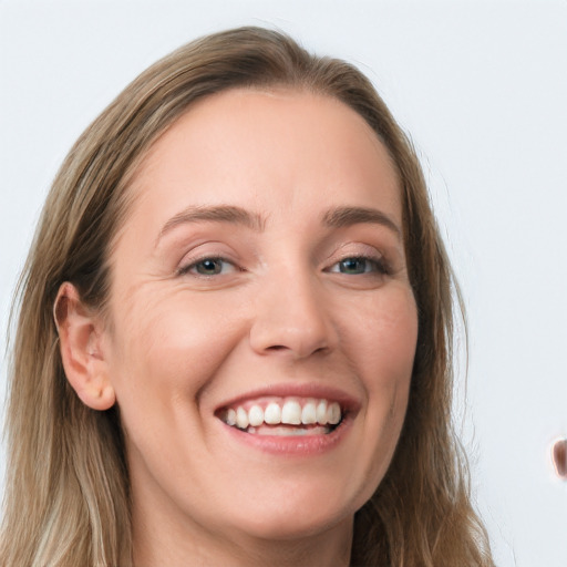 Joyful white young-adult female with long  brown hair and grey eyes