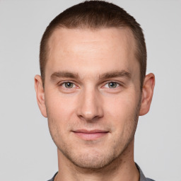 Joyful white young-adult male with short  brown hair and grey eyes