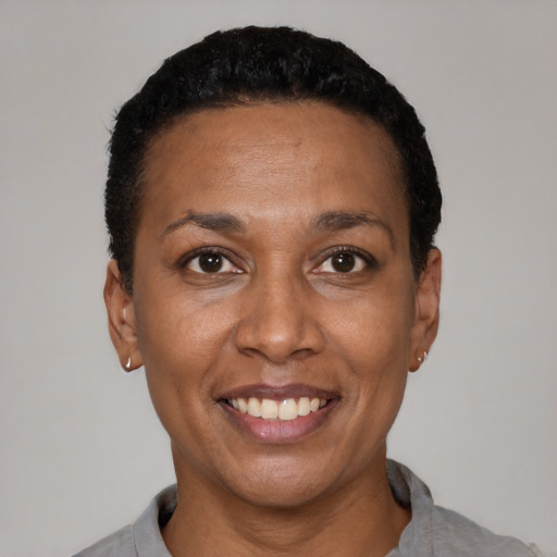 Joyful latino adult female with short  black hair and brown eyes