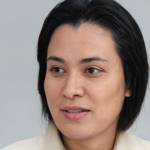 Joyful asian adult female with medium  brown hair and brown eyes