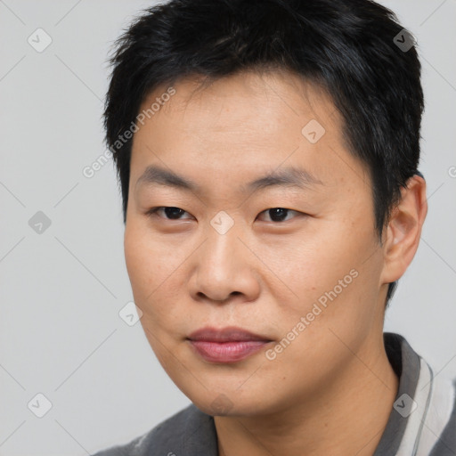 Joyful asian young-adult male with short  black hair and brown eyes