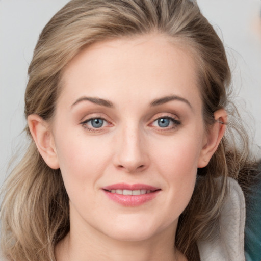 Joyful white young-adult female with medium  brown hair and blue eyes