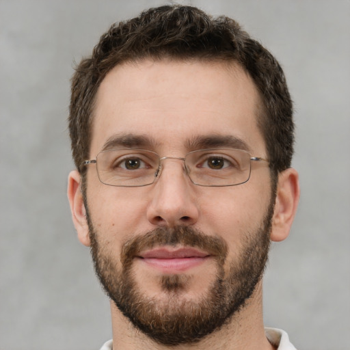 Joyful white young-adult male with short  brown hair and brown eyes