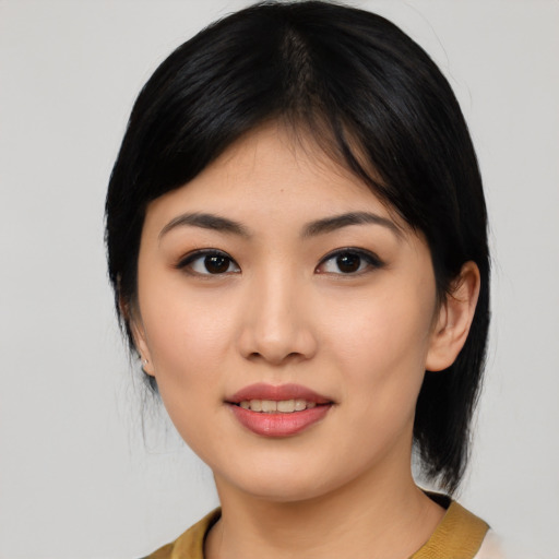 Joyful asian young-adult female with medium  black hair and brown eyes