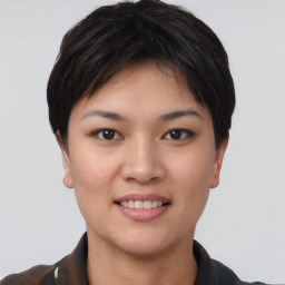 Joyful asian young-adult female with short  brown hair and brown eyes