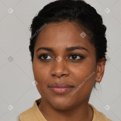 Joyful black young-adult female with short  brown hair and brown eyes