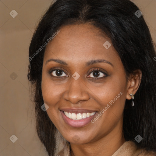 Joyful black adult female with long  brown hair and brown eyes