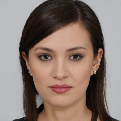 Joyful white young-adult female with long  brown hair and brown eyes