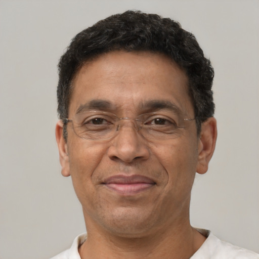 Joyful latino adult male with short  brown hair and brown eyes