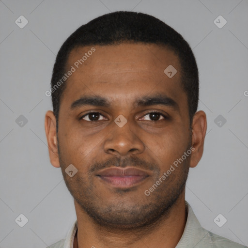 Joyful black young-adult male with short  brown hair and brown eyes