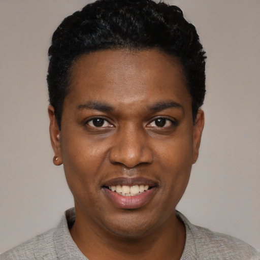 Joyful black young-adult male with short  black hair and brown eyes