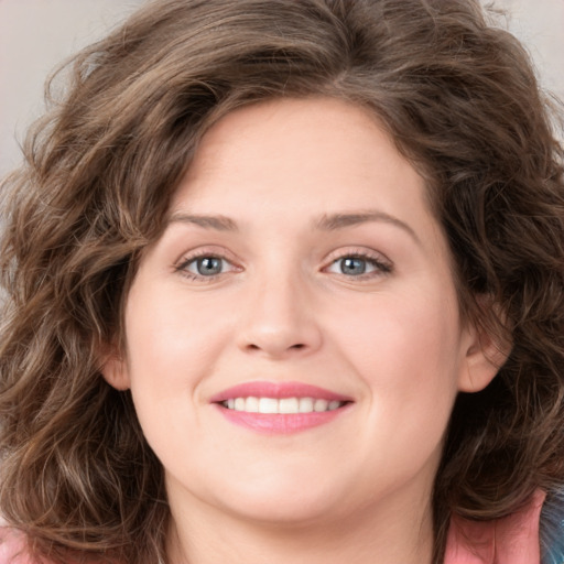 Joyful white young-adult female with medium  brown hair and green eyes