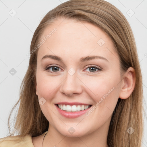 Joyful white young-adult female with long  brown hair and blue eyes