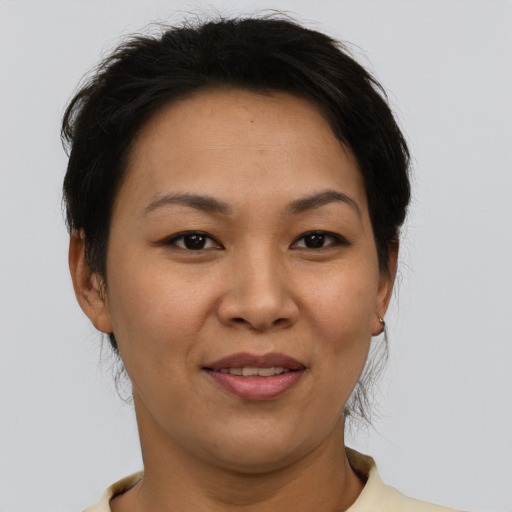 Joyful asian young-adult female with short  brown hair and brown eyes