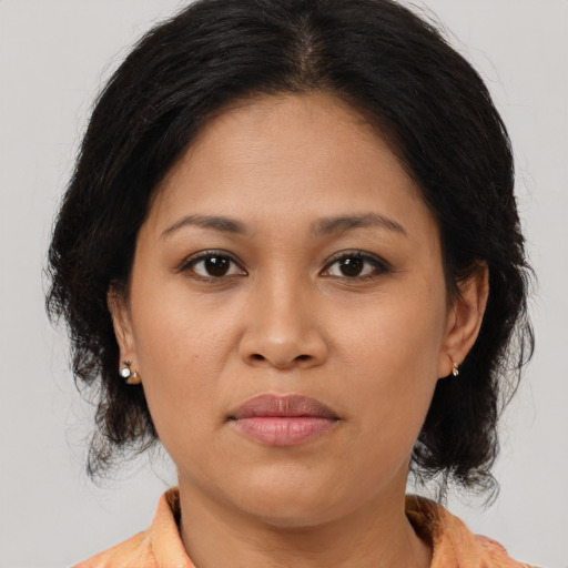 Joyful asian young-adult female with medium  brown hair and brown eyes