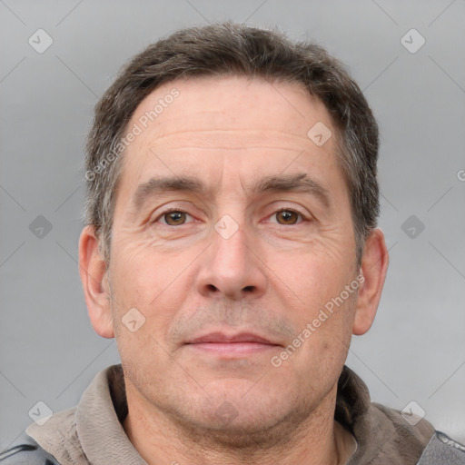 Joyful white adult male with short  brown hair and grey eyes