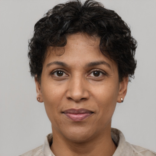 Joyful black adult female with short  brown hair and brown eyes