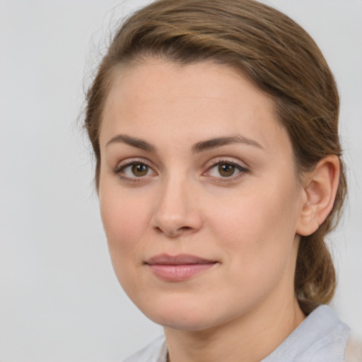 Joyful white young-adult female with medium  brown hair and green eyes