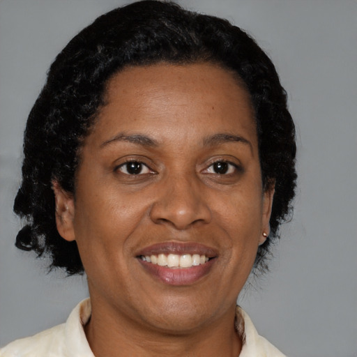 Joyful black adult female with short  brown hair and brown eyes