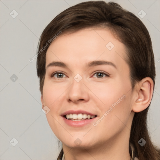 Joyful white young-adult female with long  brown hair and brown eyes