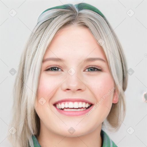 Joyful white young-adult female with medium  brown hair and blue eyes