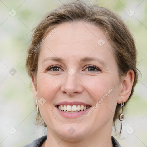 Joyful white young-adult female with medium  brown hair and blue eyes