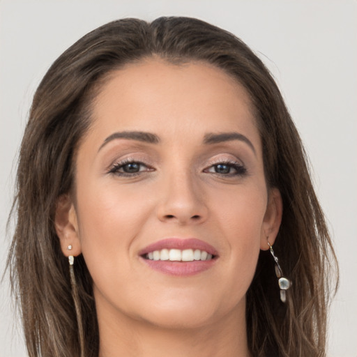 Joyful white young-adult female with long  brown hair and grey eyes