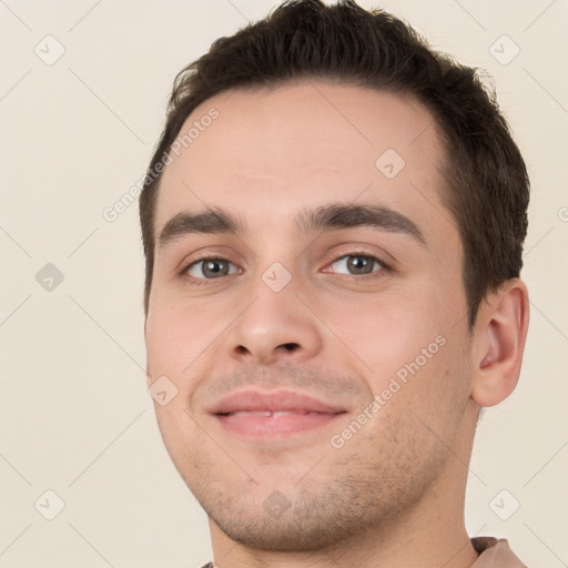 Joyful white young-adult male with short  brown hair and brown eyes