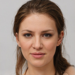 Joyful white young-adult female with medium  brown hair and grey eyes