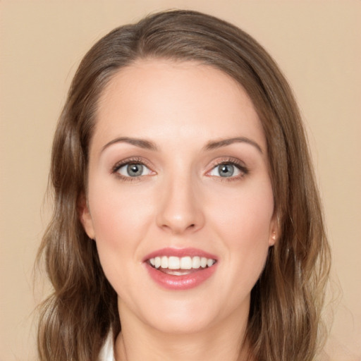 Joyful white young-adult female with medium  brown hair and green eyes