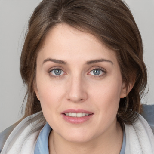 Joyful white young-adult female with medium  brown hair and blue eyes