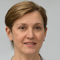 Joyful white adult female with short  brown hair and grey eyes