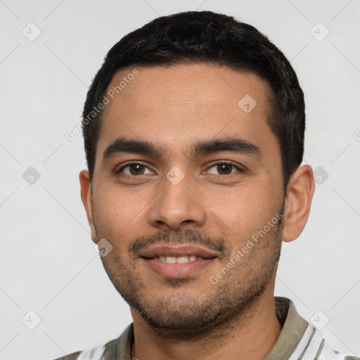 Joyful latino young-adult male with short  black hair and brown eyes