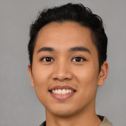 Joyful latino young-adult male with short  black hair and brown eyes