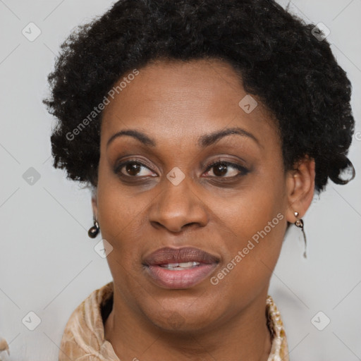 Joyful black adult female with long  brown hair and brown eyes