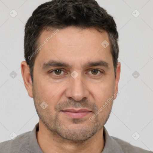 Joyful white adult male with short  brown hair and brown eyes