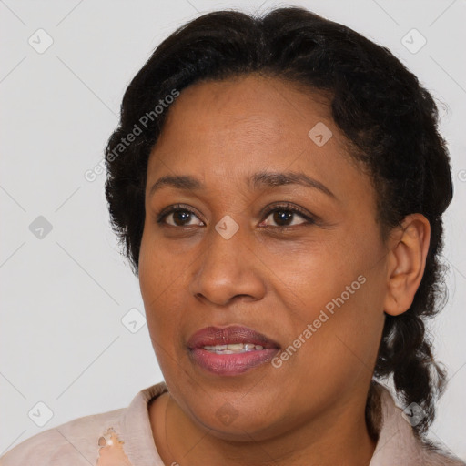 Joyful black adult female with short  brown hair and brown eyes