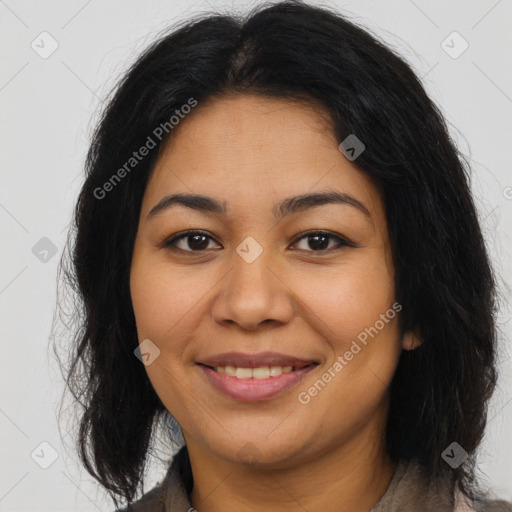 Joyful latino young-adult female with long  brown hair and brown eyes