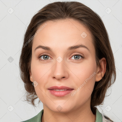 Joyful white young-adult female with medium  brown hair and green eyes