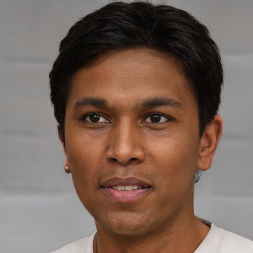 Joyful asian young-adult male with short  black hair and brown eyes