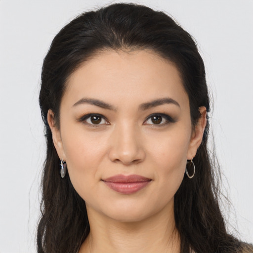 Joyful latino young-adult female with long  brown hair and brown eyes