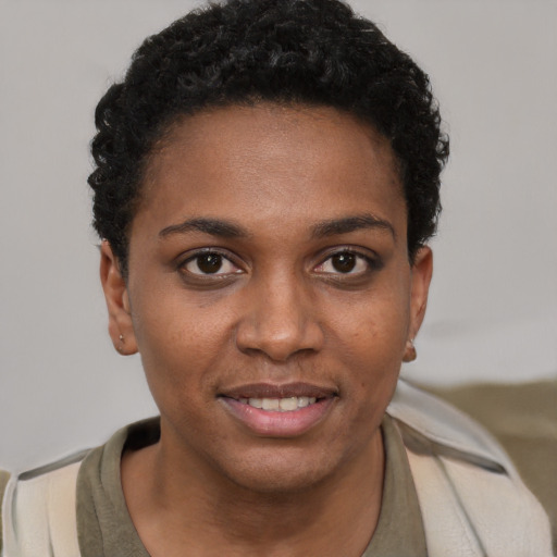Joyful black young-adult female with short  brown hair and brown eyes