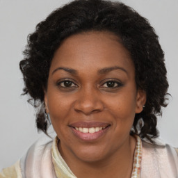 Joyful black young-adult female with medium  brown hair and brown eyes