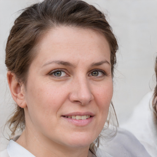 Joyful white adult female with medium  brown hair and grey eyes