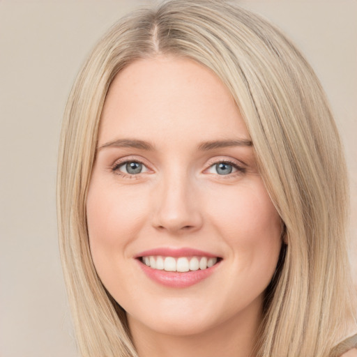 Joyful white young-adult female with long  brown hair and green eyes