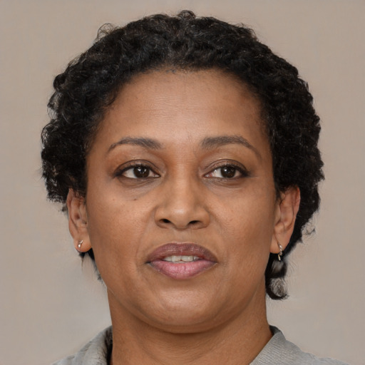 Joyful black adult female with short  brown hair and brown eyes