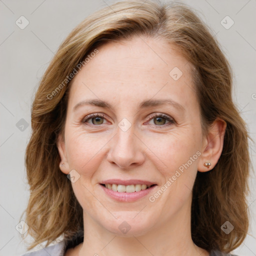 Joyful white adult female with medium  brown hair and blue eyes