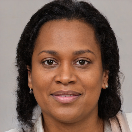Joyful black young-adult female with medium  brown hair and brown eyes