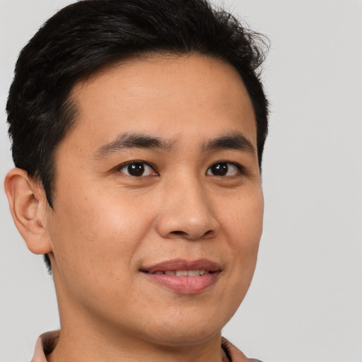 Joyful asian young-adult male with short  brown hair and brown eyes