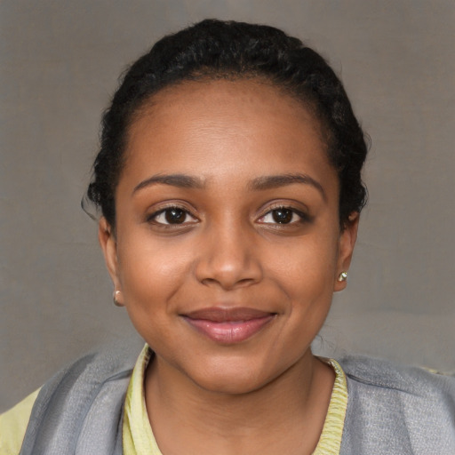 Joyful black young-adult female with short  black hair and brown eyes